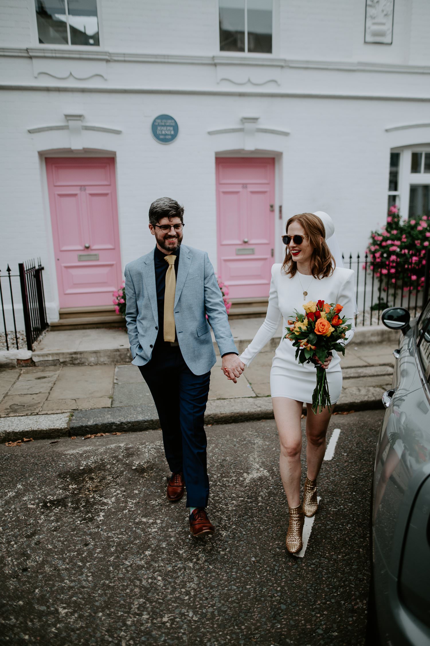 A bride and groom married at Chelsea Town Hall take cool wedding portraits all over London.