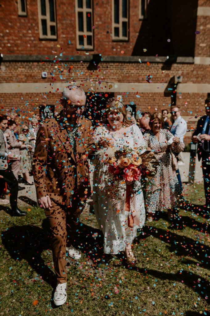 Wedding guests throw confetti at a bride and groom at their wedding at Left Bank in Leeds.