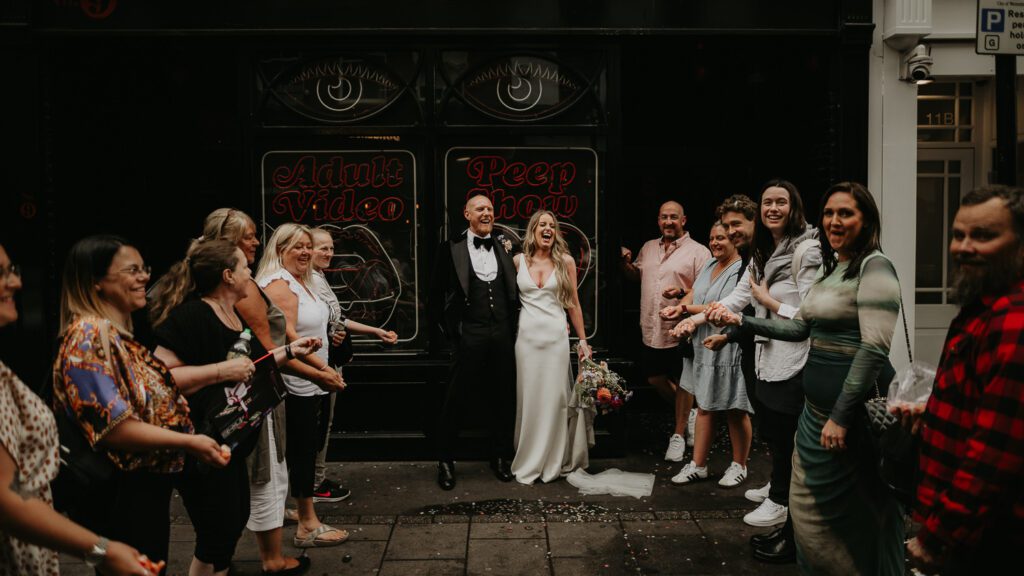 Strangers throw confetti at a London Elopement in Soho.
