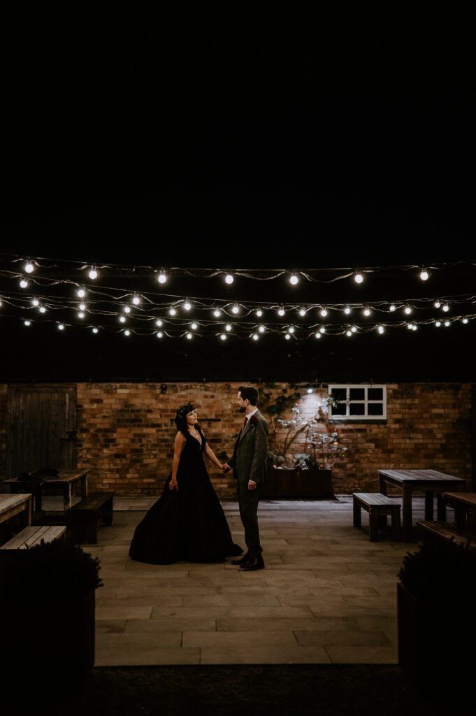 A bride surprises her groom with a black wedding dress for the evening of their wedding.