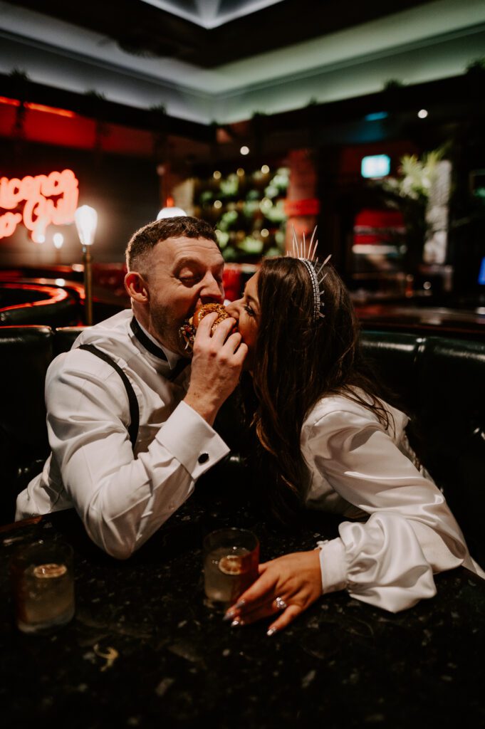 Bride and groom share a burger at Beefy boys on their wedding night.