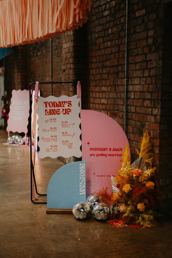 Alternative Wedding welcome signs at a wedding in a warehouse.