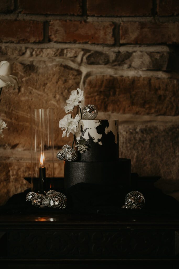 Black wedding cake with white accents.