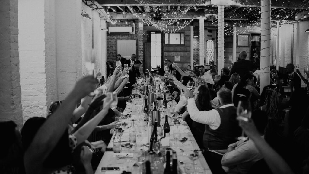 Wedding guests raise their glasses for a toast at 100 Barrington.