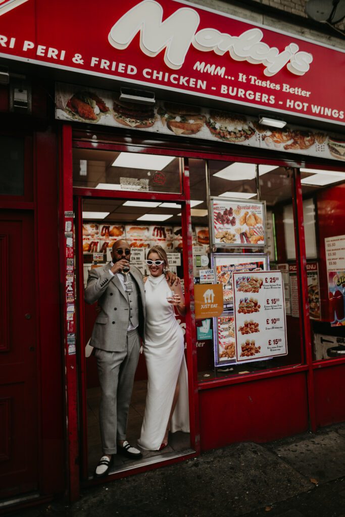 A Bride and Groom outside Morley's Chicken in Brixton.