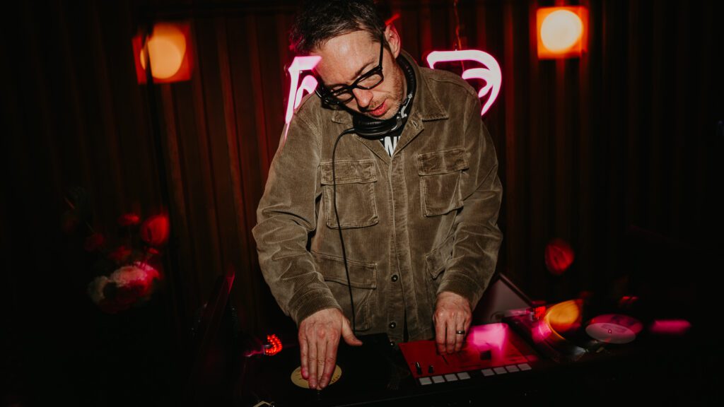 DJ plays at a wedding at Ducie Street Warehouse in Manchester.