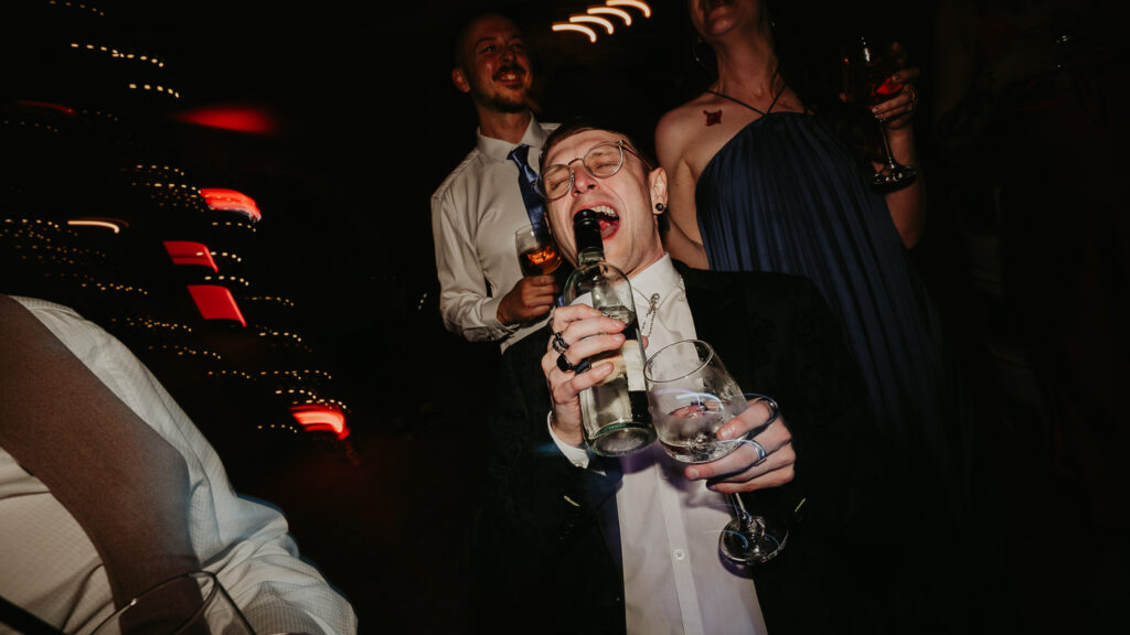 Wedding guests singing on the dance floor at their friends emo wedding in Newcastle.