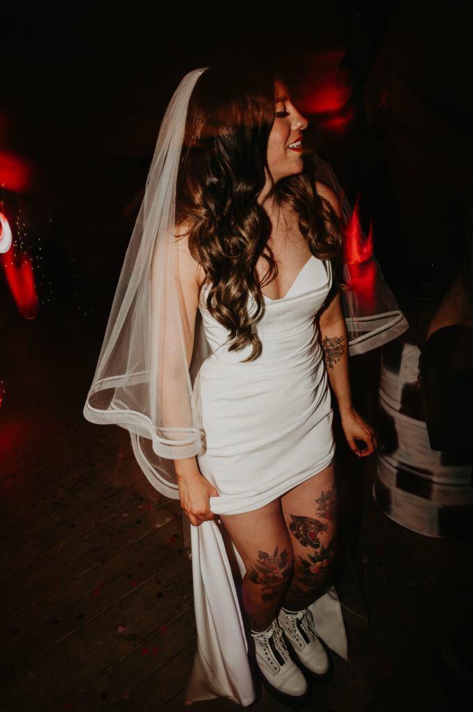 Tattooed bride dances on the dance floor at her emo wedding in Newcastle.