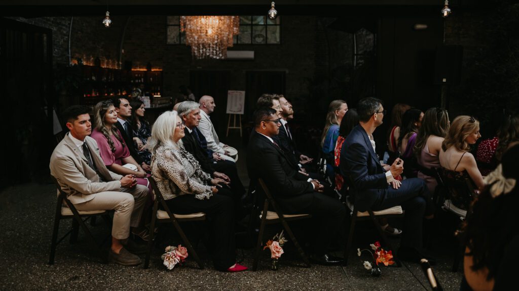 Guests sit during an outside wedding ceremony in London.