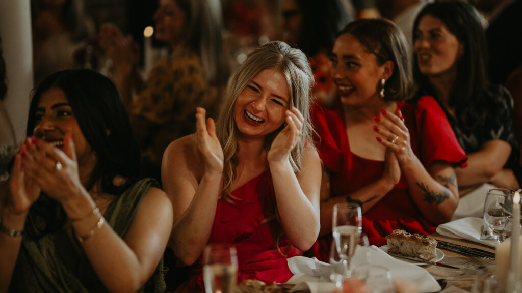 Bridesmaid reacts to a speech at a London wedding.
