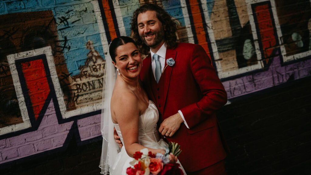 Bride and Groom in front of the Brixton mural on their wedding day.