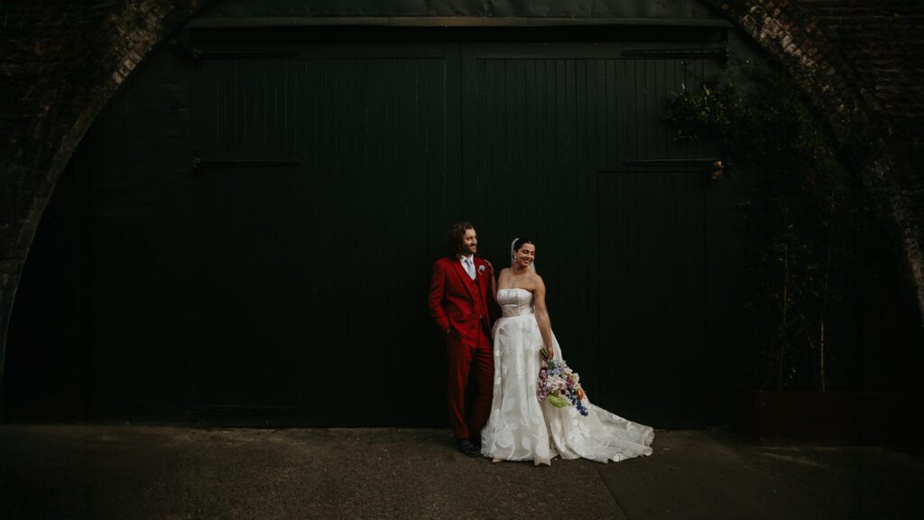 Bride and groom in front of the large black barn doors at 100 Barrington.