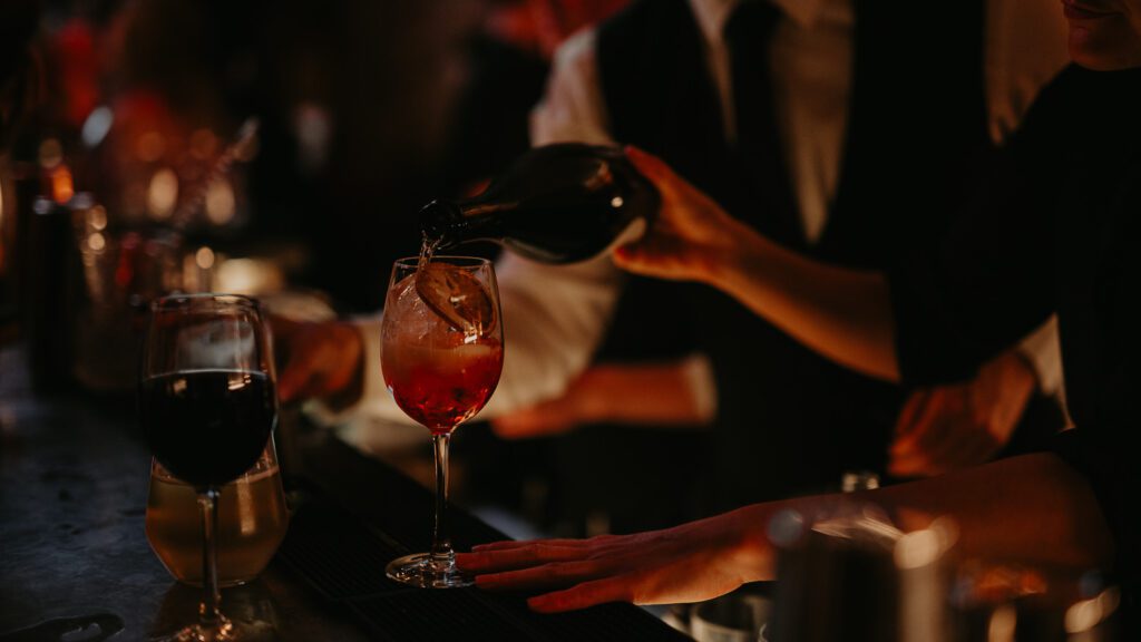Bar staff at 100 Barrington pour a drink.