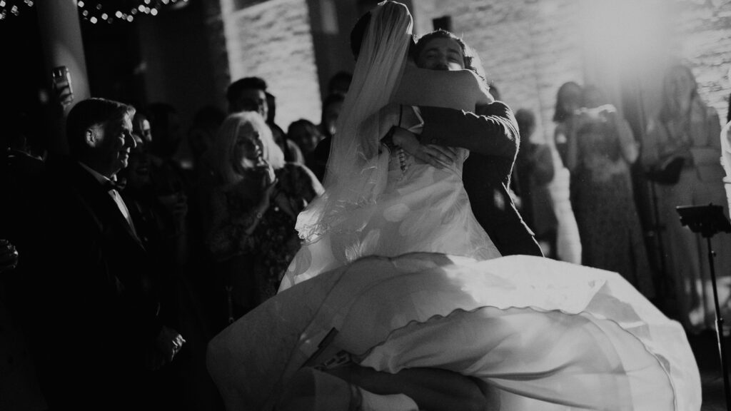 Groom spins his bride around during their first dance in London.