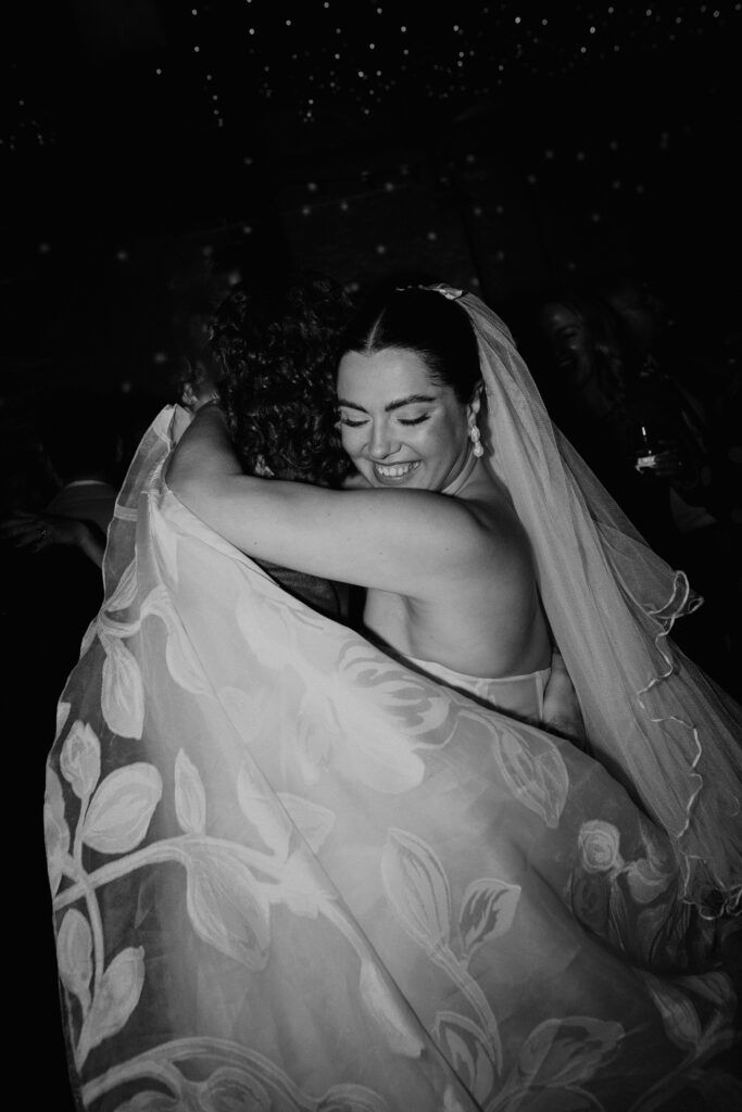 A bride smiles during her first dance at her wedding in London.