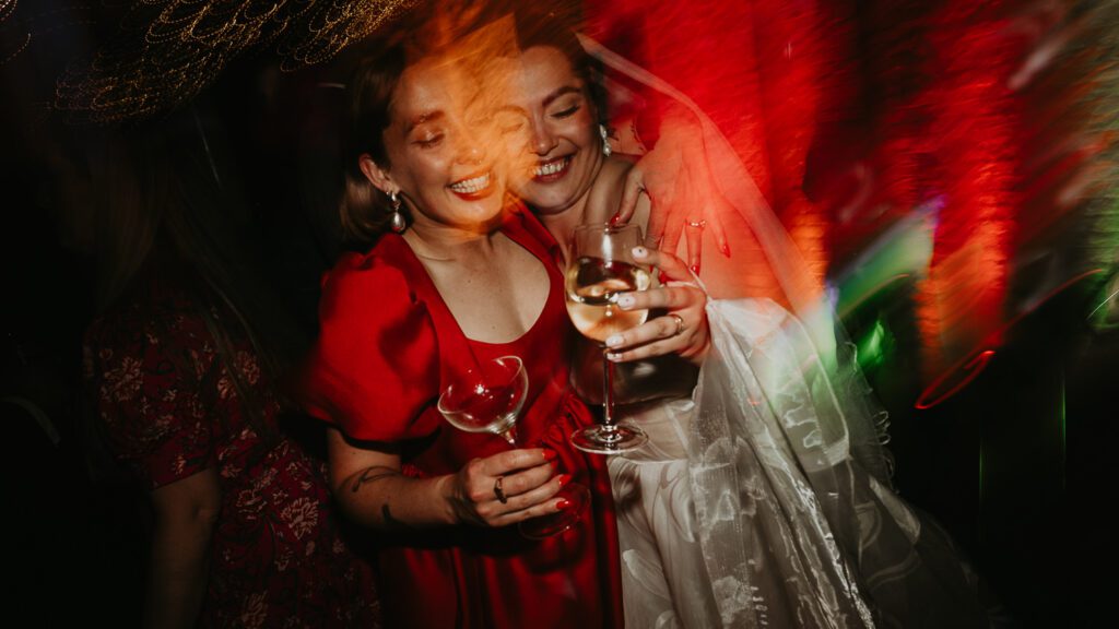 Bride and bridesmaid dance at a London wedding at 100 Barrington.