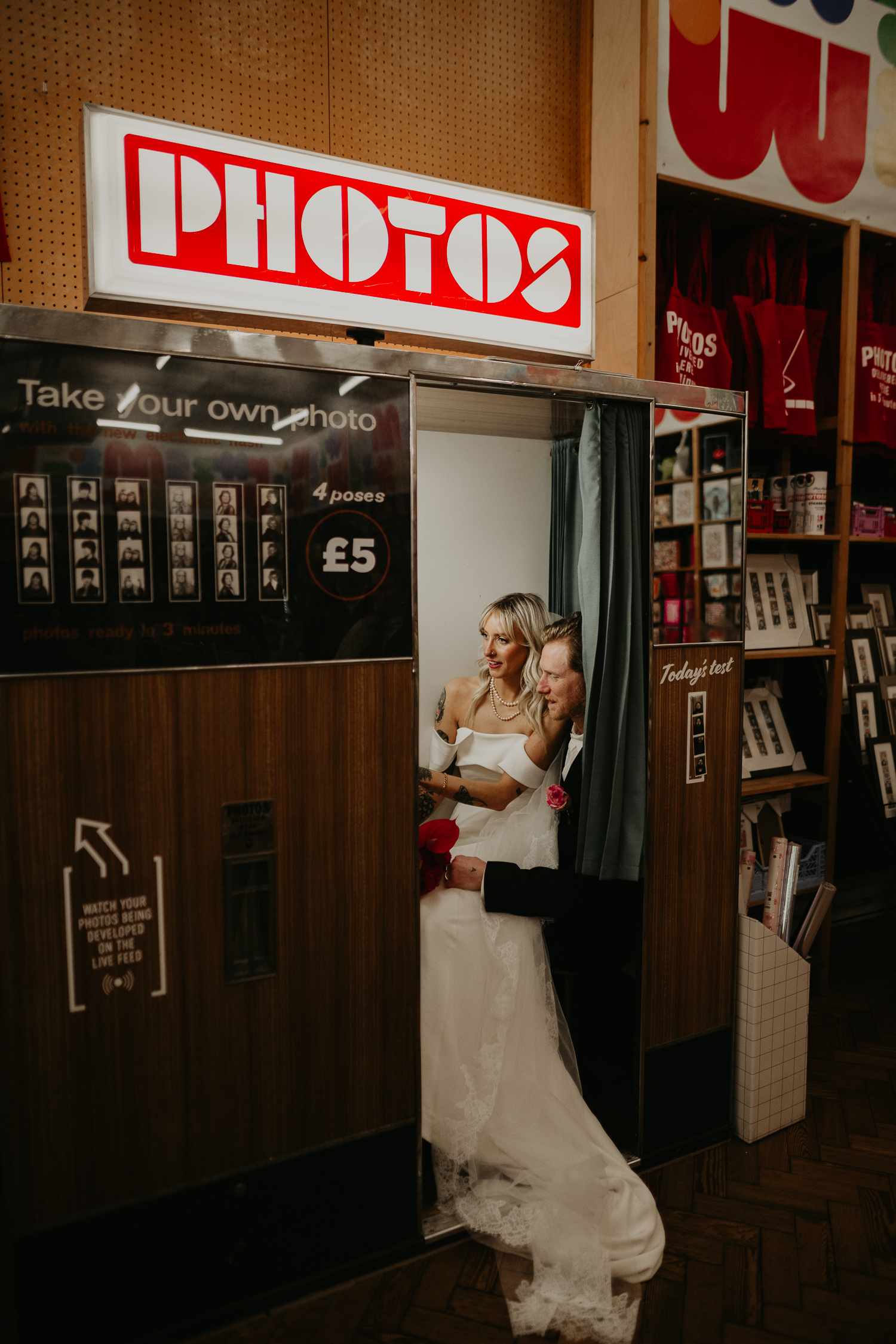 Bride and groom inside a photo booth in Manchester city centre on their wedding day.