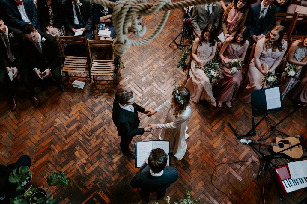 A couple share their vows at Clapton Country Club in London. The venue is an old renovated tram shed who puts on an awesome London wedding.