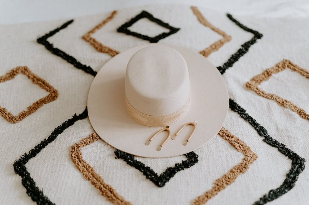 A wide brimmed hat from lack of color Aus sits on a boho bead spread.