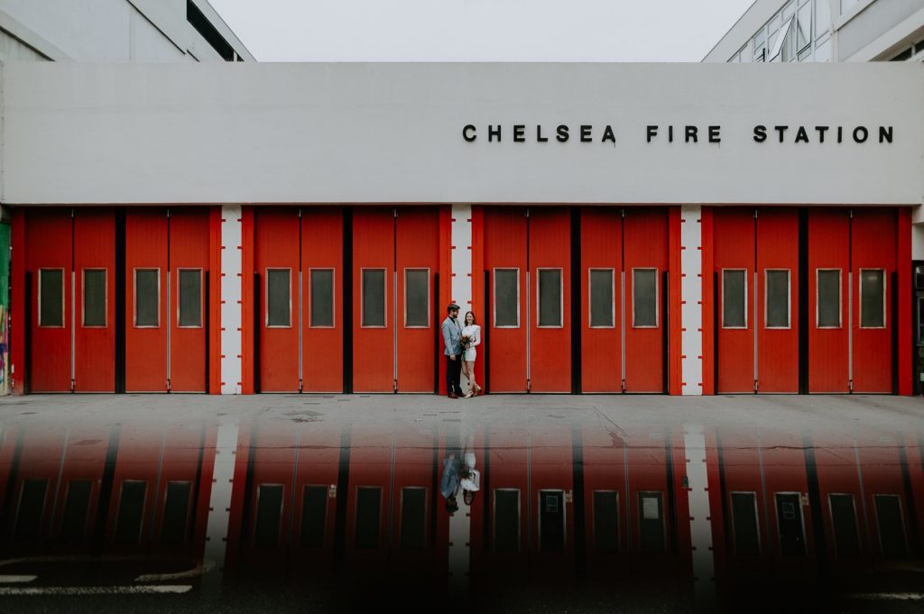 A couple kiss outside of Chelsea Fire Station after they married at Chelsea Town Hall.