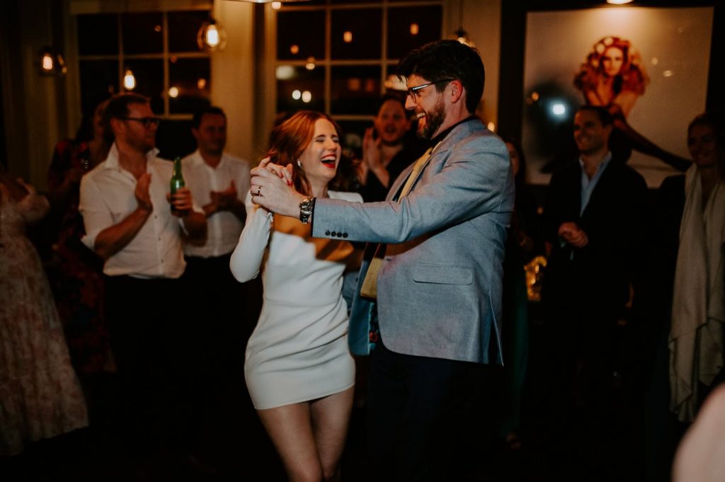 A bride and groom dance at their wedding reception at The Great Guns in London.