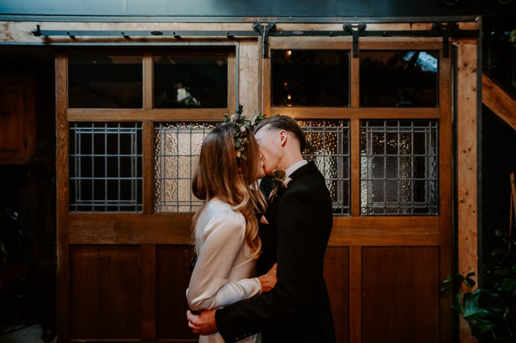 A bride and grooms first kiss at Clapton Country Club.