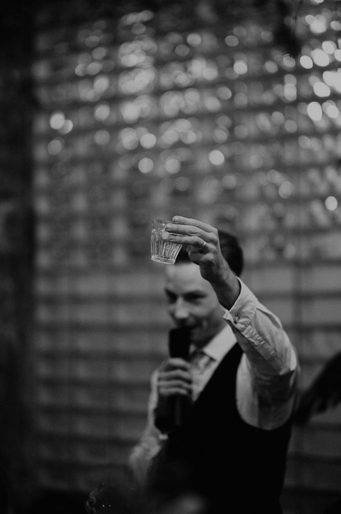 A Groom raises a glass during his speech at Clapton Country Club