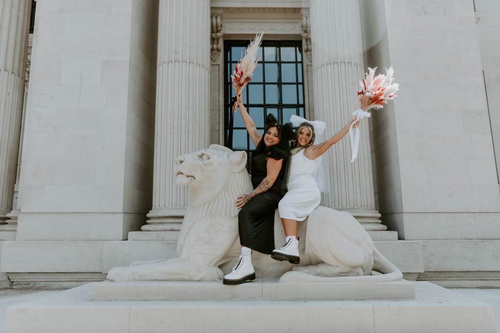 Two brides ride the lion outside Marylebone Town Hall