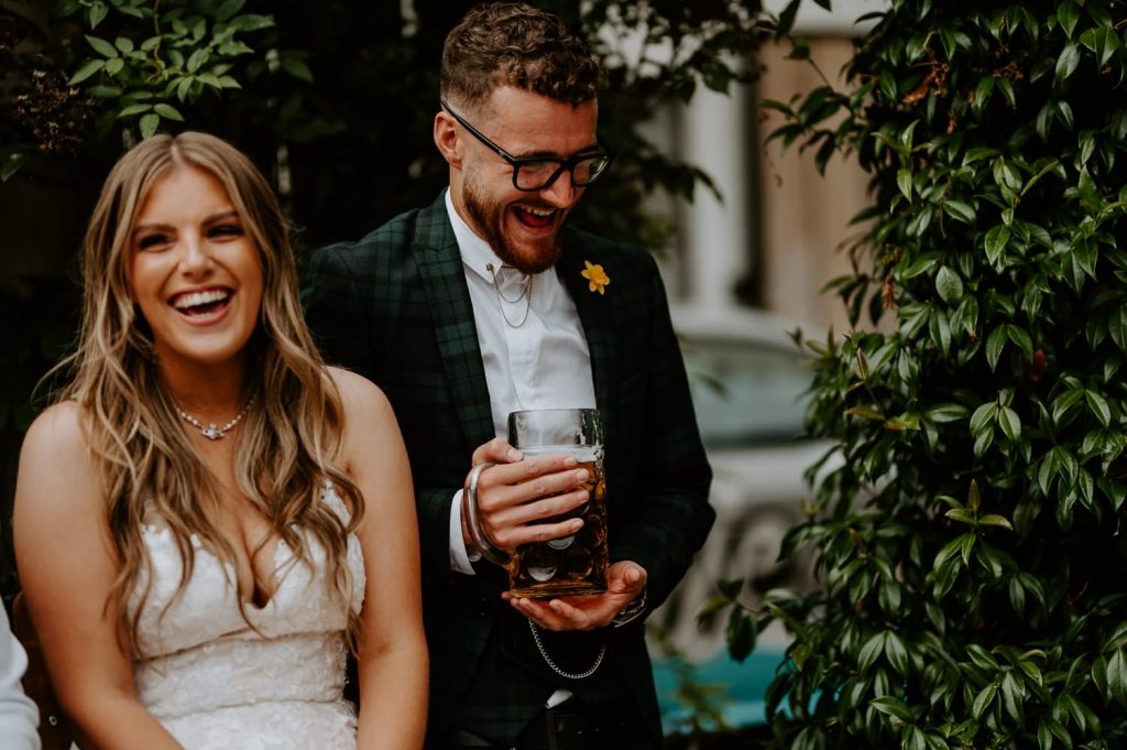 A bride and groom laugh during speeches at the shack revolution.