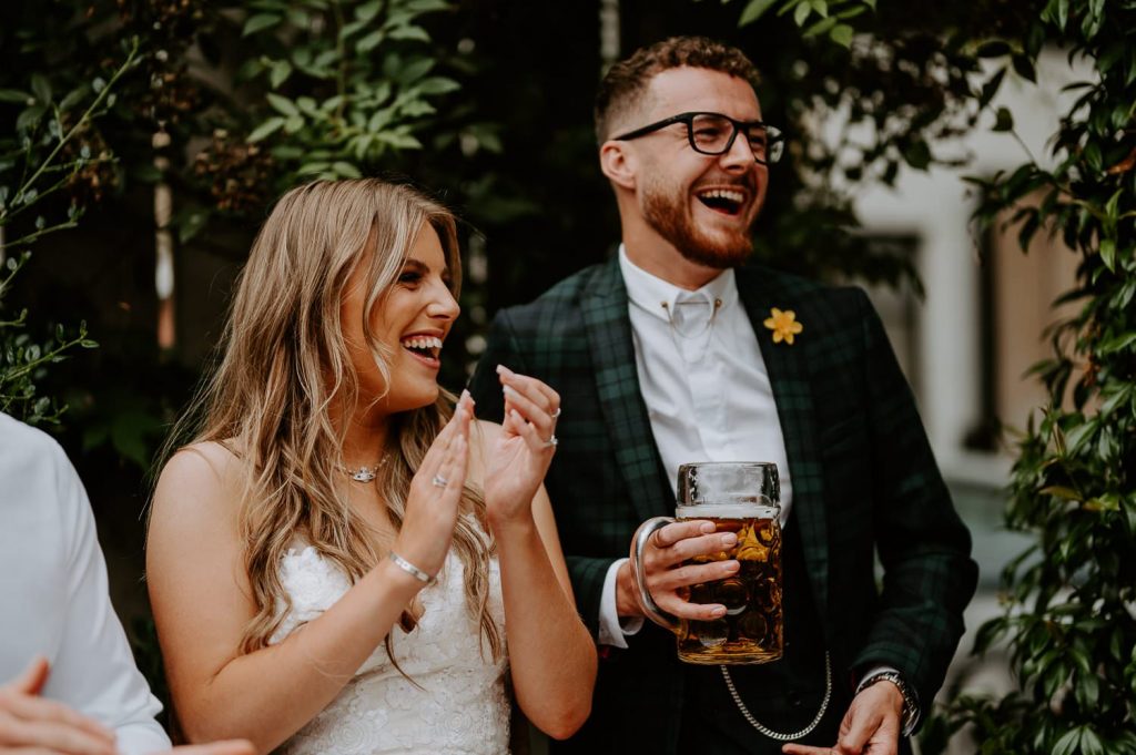 A bride and groom laugh at a speech at the shack revolution