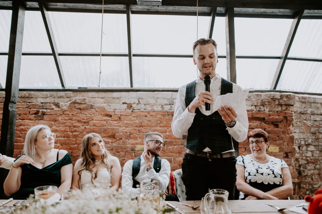 A groomsman delivers his speech at the shack revolution.