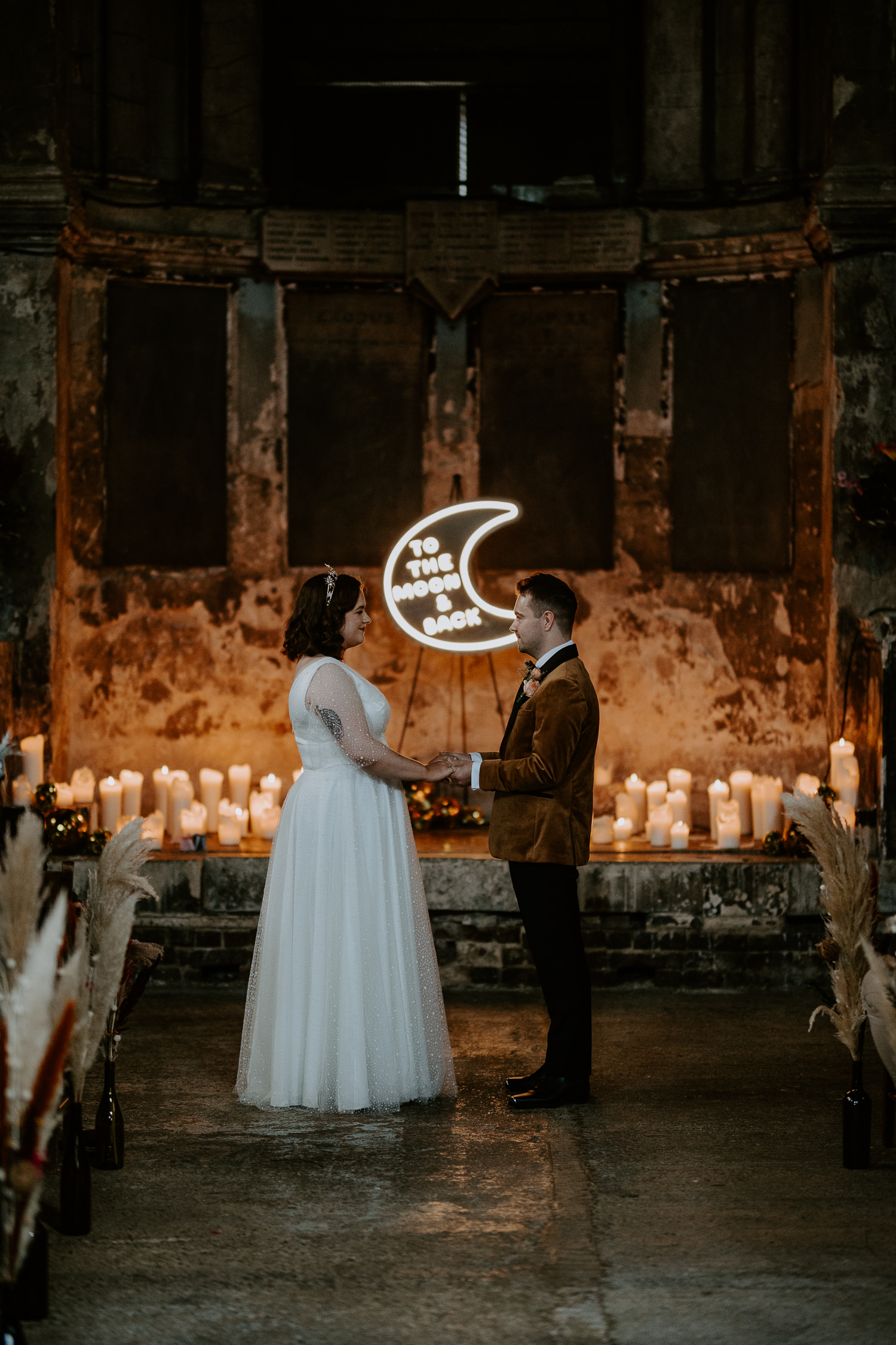 A couple get married at The Asylum Chapel in Peckham, London. The venue is untradtional and has some awesome features like the exposed brick, huge windows letting in all the natural light and the fact it is a black canvas venue so yo can really put your own style into it.