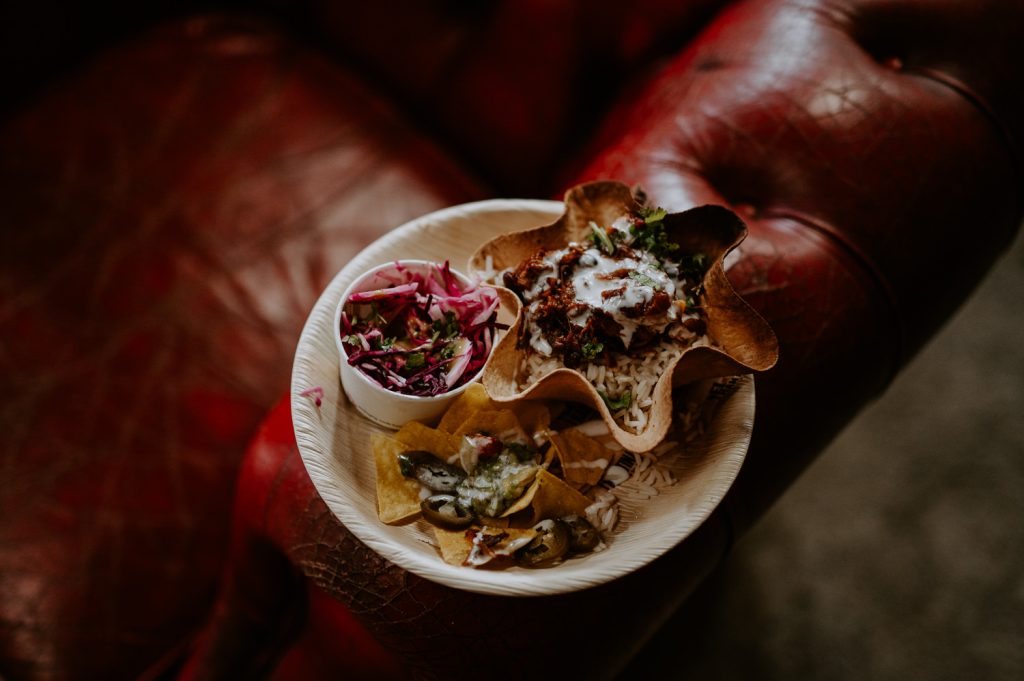 Mexican nacho bowl on the air of a sofa at a wedding.