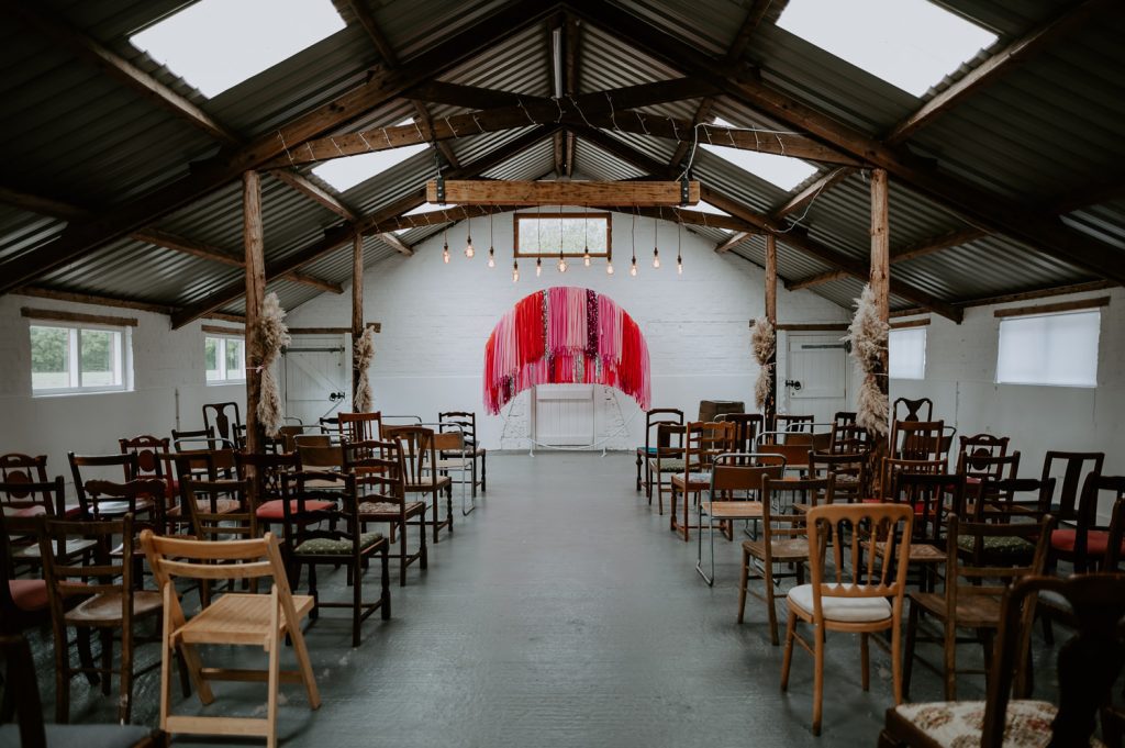 The white barn at White Syke Fields with a DIY pink streamer backdrop.