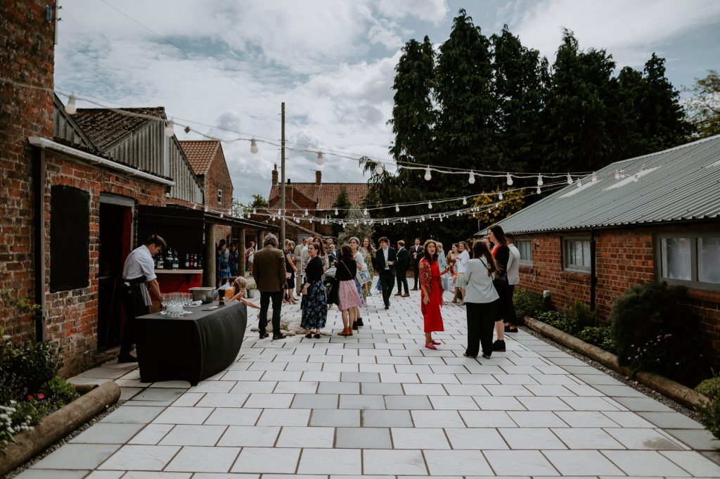 The courtyard at White Sykes Fields filled with wedding guests.