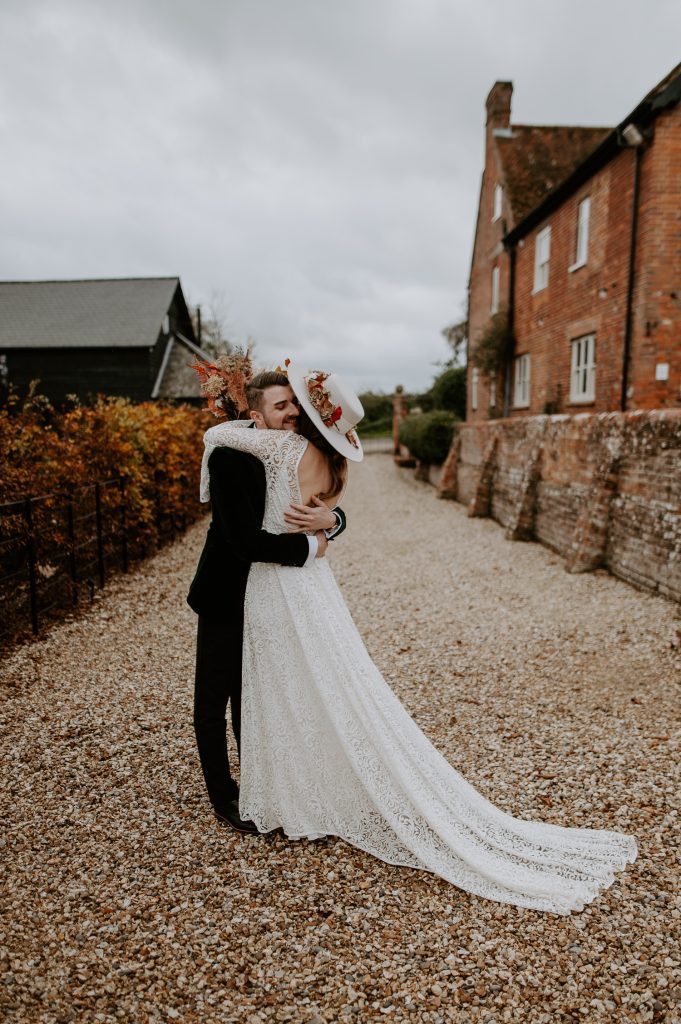 Bride and groom hug during first look.