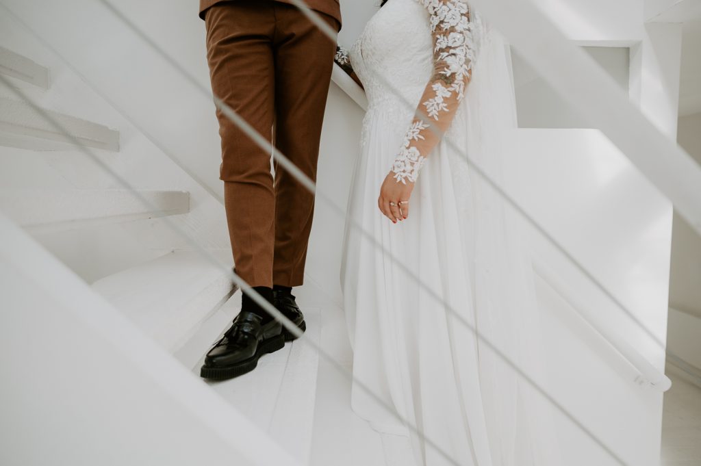 Detail shots of a bride and groom against the white wall at Five Four Studios.