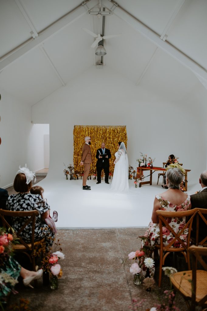 A wide shot of a stylishly colourful wedding at Five Four Studios in Manchester.