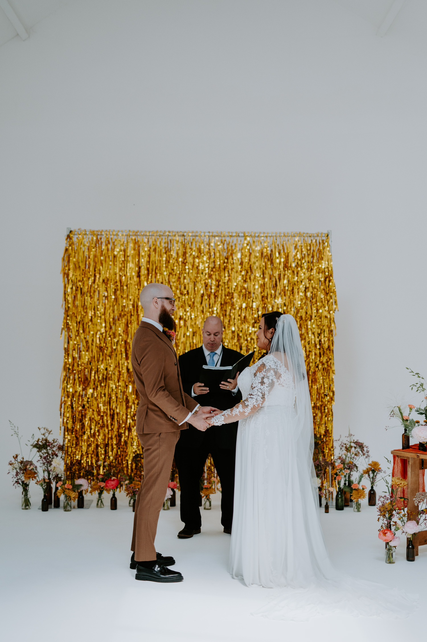 A bride and groom get married at fivefourstudios photography studio.