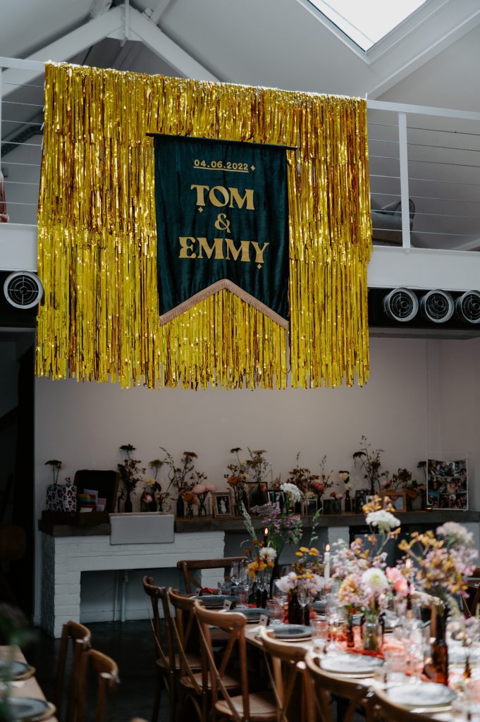 Great custom wedding banner hanging over a mezzanine at a stylishly colourful wedding at Five Four Studios.