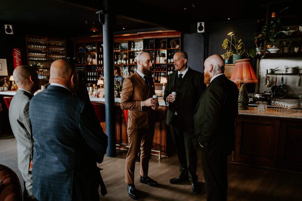 Groomsmen gather in the bar at Five Four Studios.