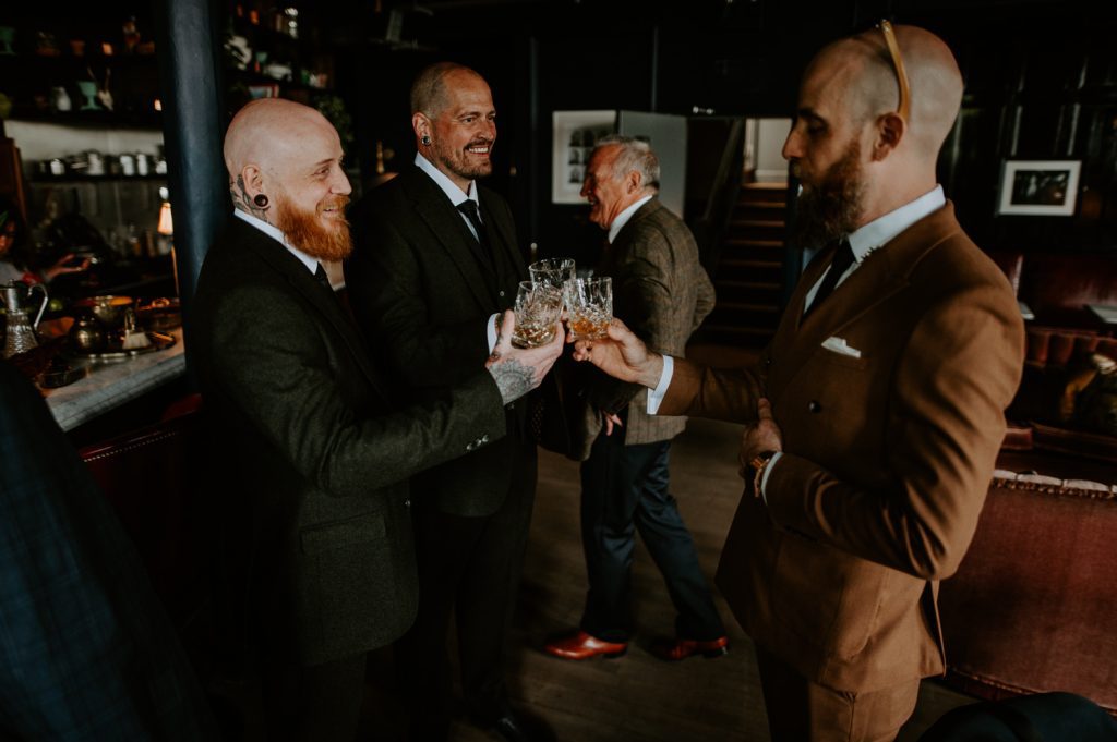 Groomsmen cheers at the bar at Five Four Studios.