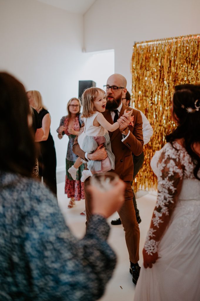 A groom dances with his daughter at a stylishly colourful wedding at Five Four Studios.