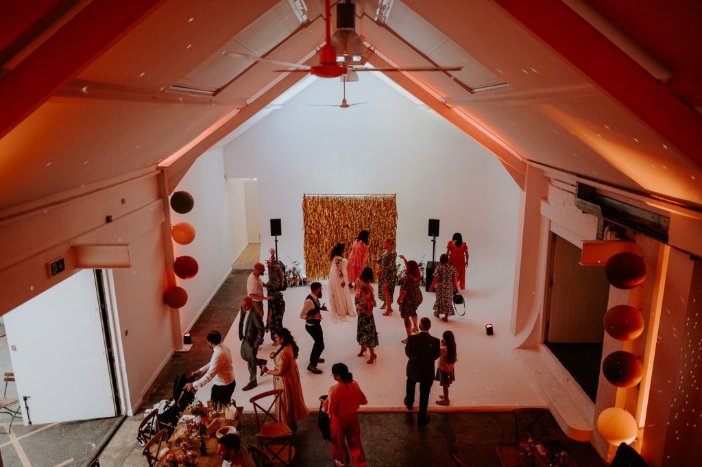 A wide shot of the dance floor at a stylishly colourful wedding at Five Four Studios