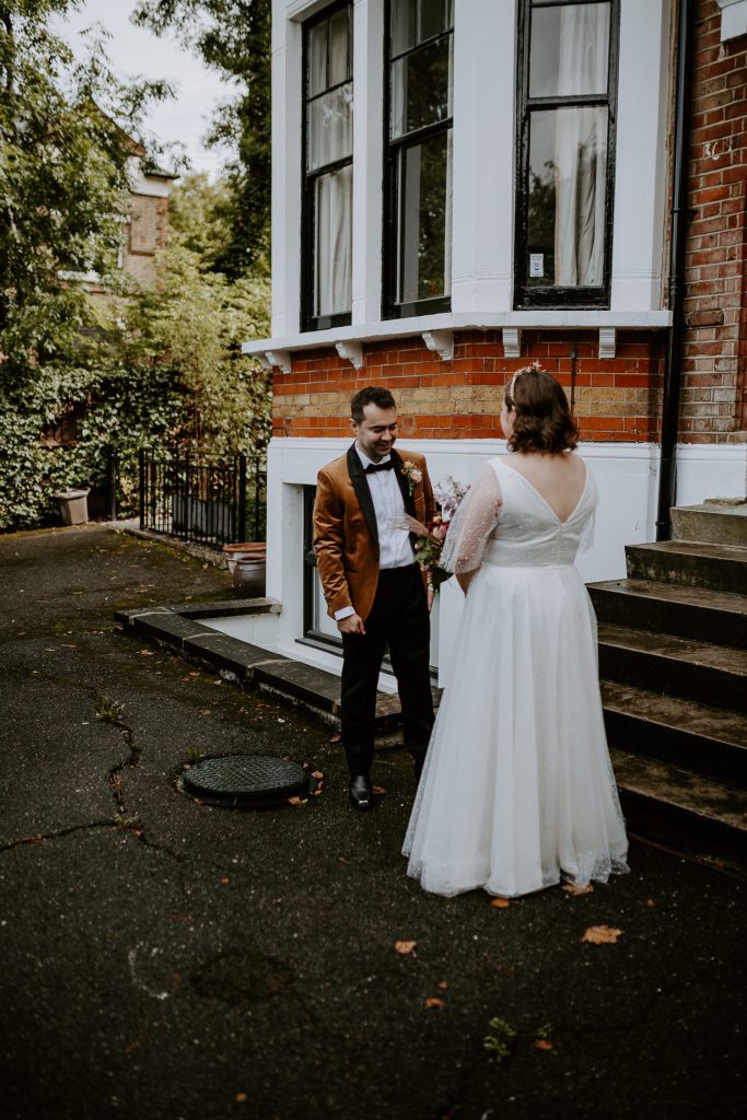 Groom reacts to seeing his bride for the first time during their first look.