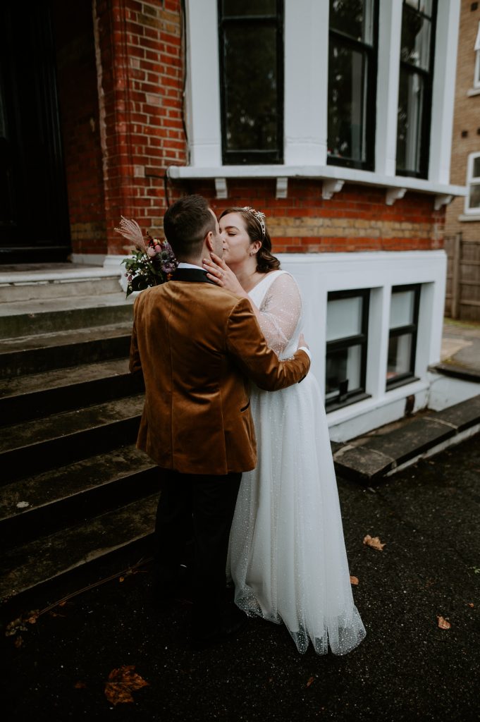 bride and groom kiss during their first look.