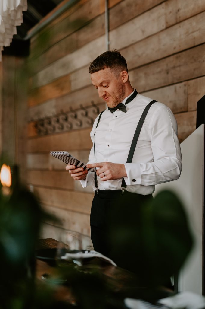 A groom delivers his speech on custom stationery at The Shack Revolution.