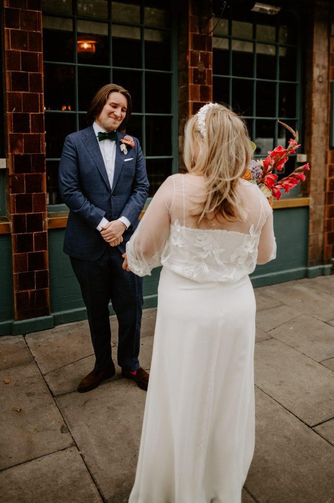 Bride and grooms first look in London outside Soho House.