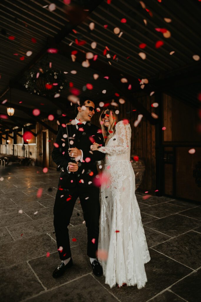 A bride and groom let off a biodegradable wedding confetti cannon at their Eco-Friendly Wedding at willow marsh farm wedding venue. 